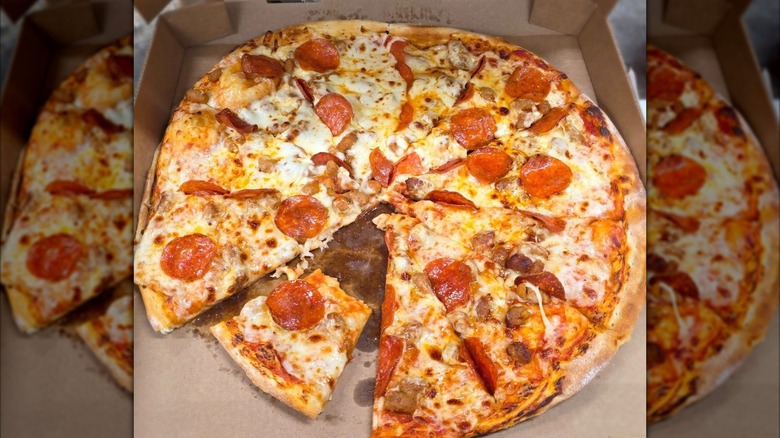 Box of Casey's pizza with one piece partially consumed