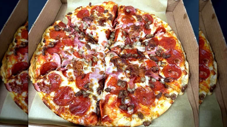 Whole Maverik pizza in box