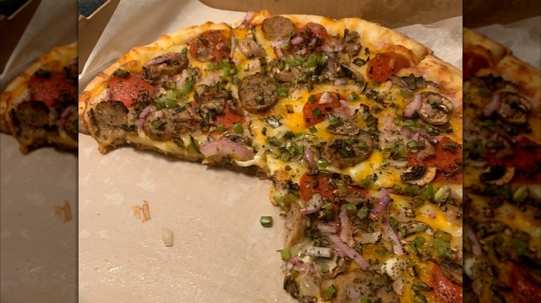 Weigel's pizza in box with pieces missing