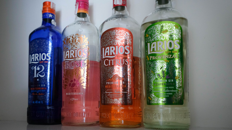 A selection of half-empty Larios bottles shown together on a plain background