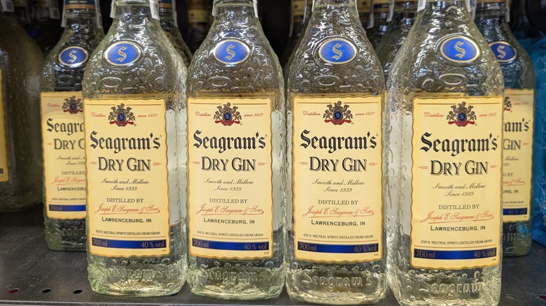 A line of Seagram's Dry Gin shown on a metal shop shelf