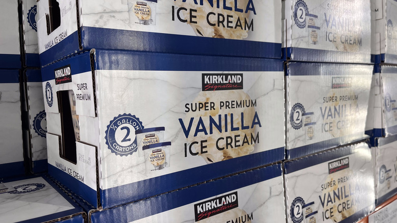 Several boxes of Kirkland Signature vanilla ice cream stacked in freezer case at Costco