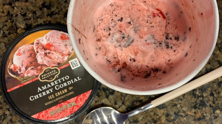 Overhead view of Amaretto Cherry Cordial ice cream carton, lid off to show ice cream inside