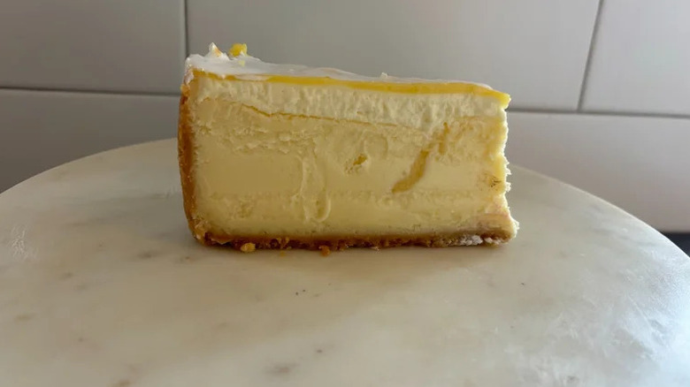Lemon Meringue Cheesecake on white pedestal