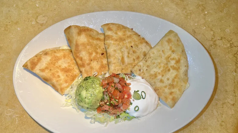 Quesadilla triangles with guacamole, salsa, and sour cream