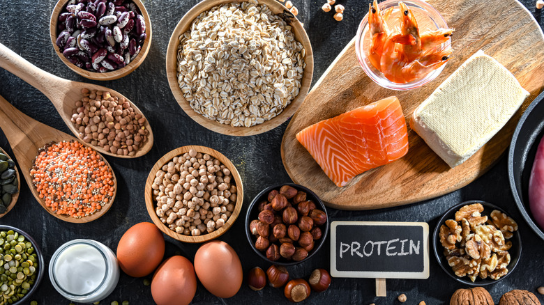 Variety of protein-rich foods on a black slate