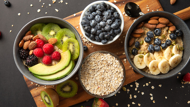 Several bowls of fiber-rich foods on wooden board