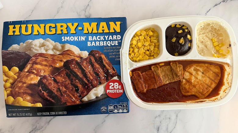 Hungry-Man Smokin' Backyard Barbeque box next to cooked meal on marble surface