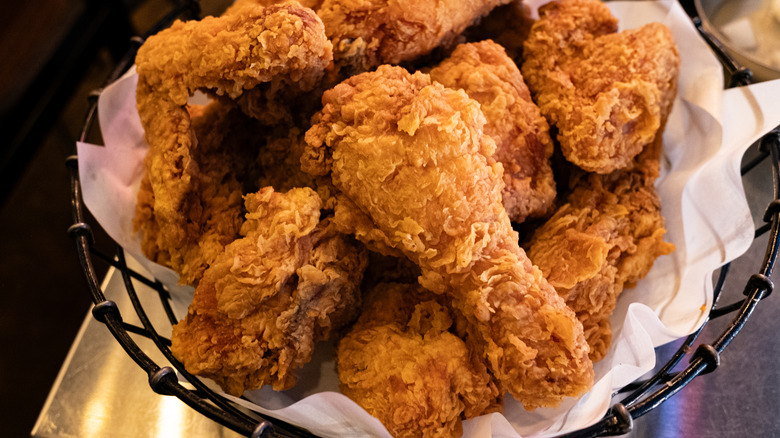 Fried chicken pieces stacked in a basket
