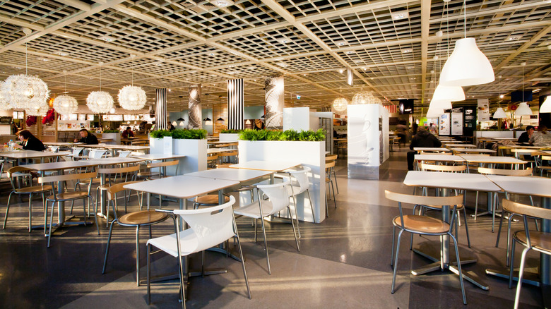 A wide view of a mostly empty IKEA food court showcasing its seating layout