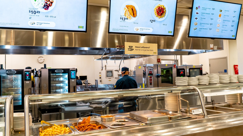 The IKEA cafeteria with food items shown and and overhead menus showing items and prices