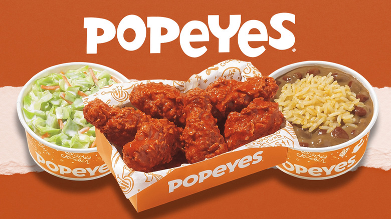 Various Popeyes dishes below Popeyes lettering on orange background