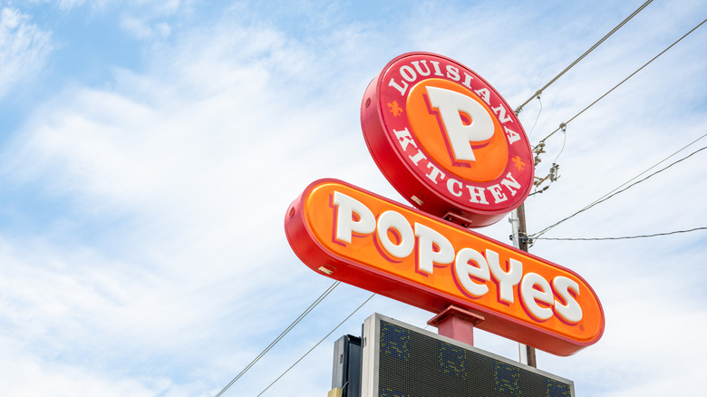 Popeyes Louisiana Kitchen sign against blue sky