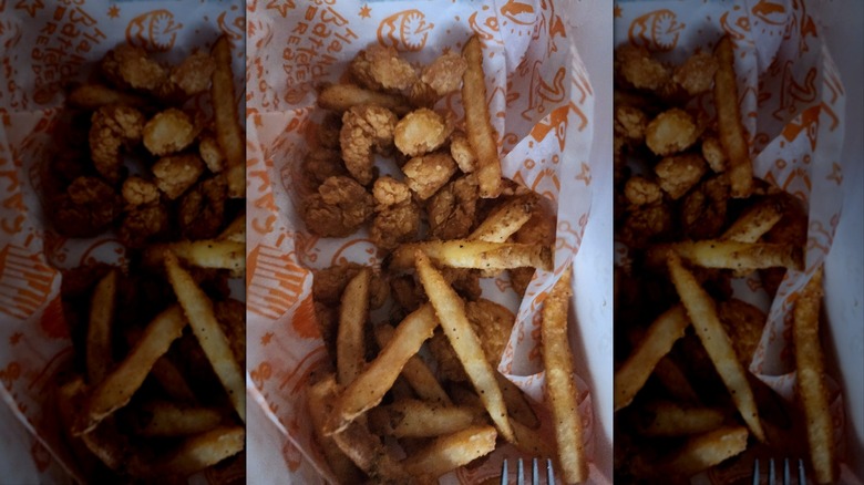 Popcorn shrimp and fries from Popeyes in paper