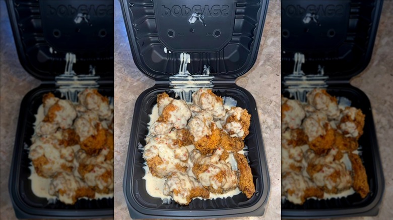Popeyes roasted garlic Parmesan wings in black to-go container