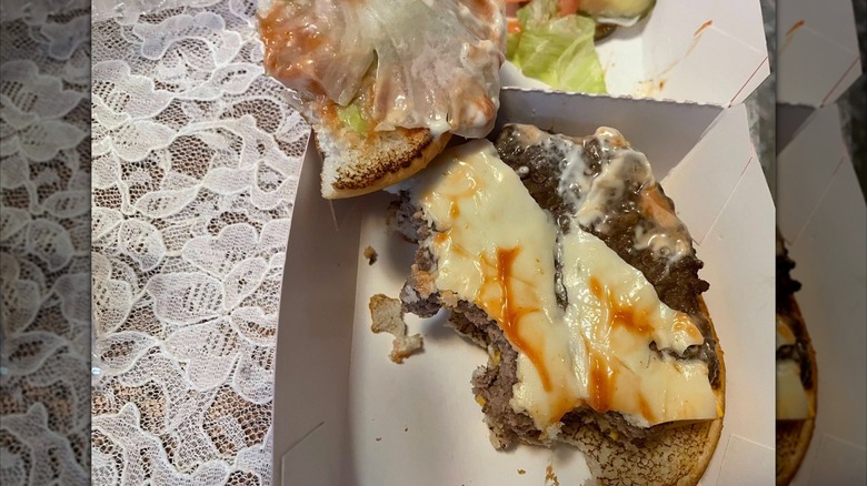 Half eaten Dairy Queen burger on table