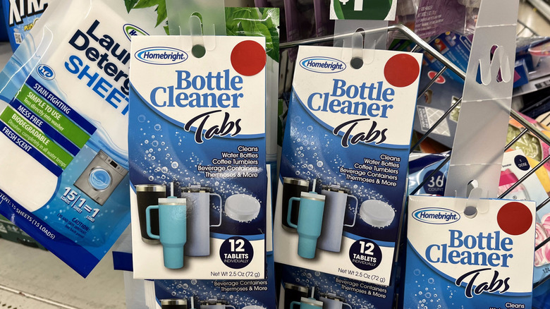 Packages of bottle cleaner tabs hanging on hooks at Dollar Tree