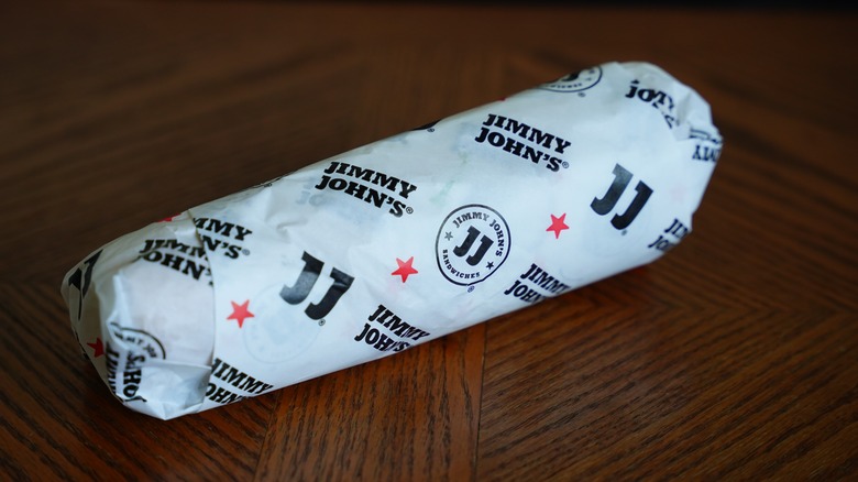 Wrapped Jimmy John's sandwich on wooden table