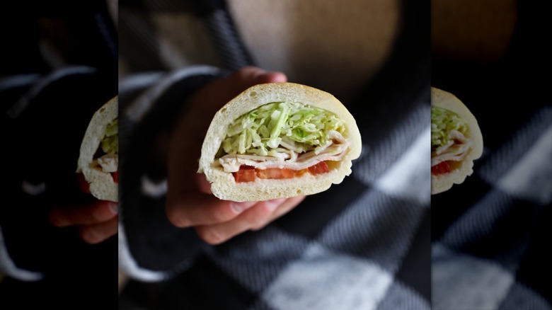 Hand holding Jimmy John's Turkey Tom sandwich