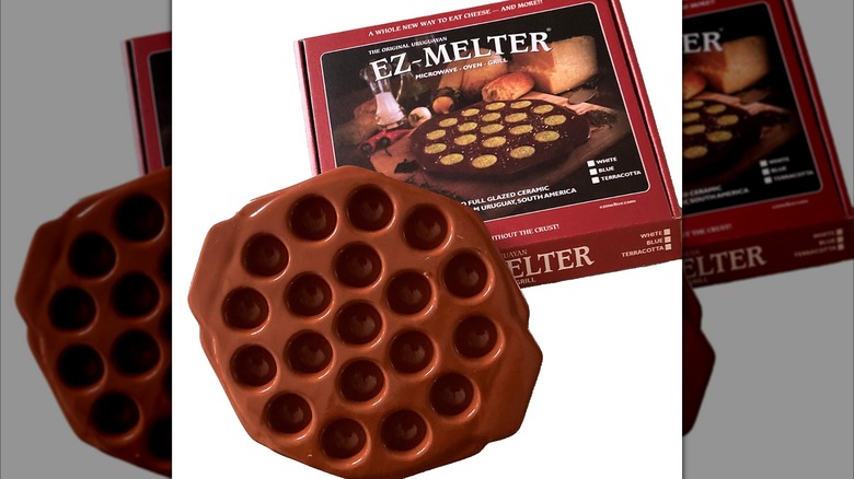 An EZ-Melter cheese provoletera & serving platter with cheese and appetizers