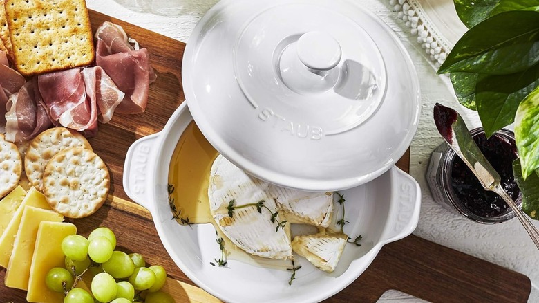 A Staub ceramic Brie baker with Brie cheese