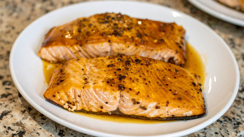 Glazed salmon filets on white plate