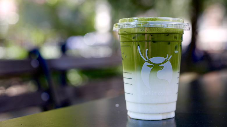 Luckin Coffee iced matcha latte on table served in a plastic cup