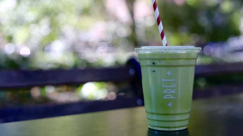 Pret A Manger iced matcha latte on table with a straw
