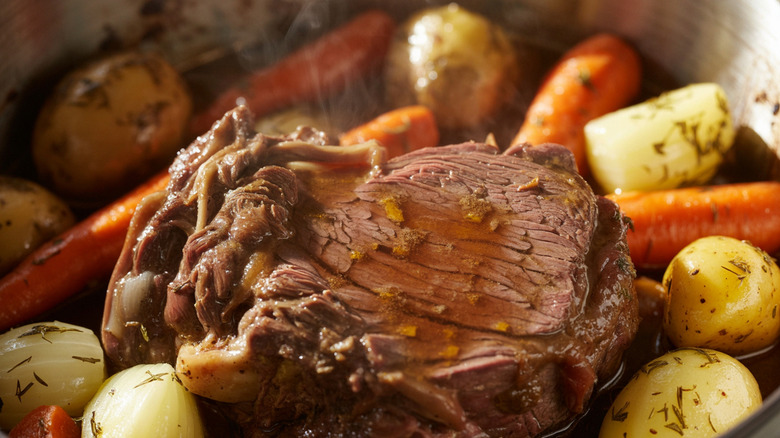 Close-up of pot roast, cut of meat surrounded by carrots and potatoes