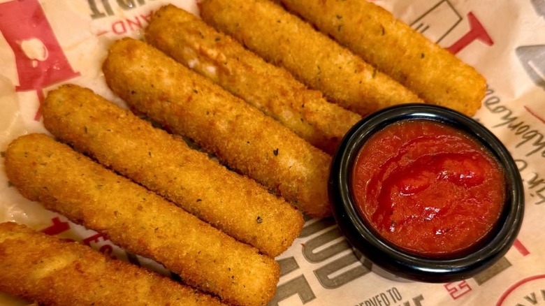 Mozzarella sticks with cup of sauce