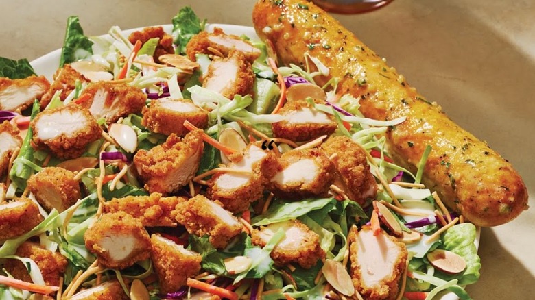 Salad with chopped chicken and breadstick