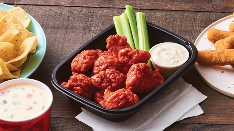 Order of boneless wings in tray with celery and dip