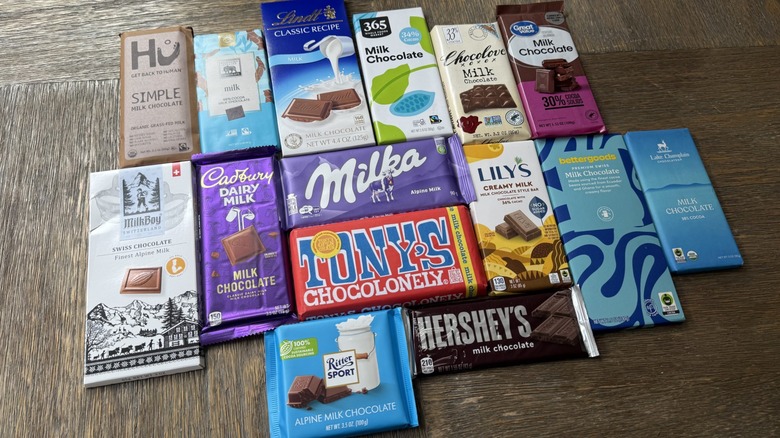 15 bars of milk chocolate from different brands on table