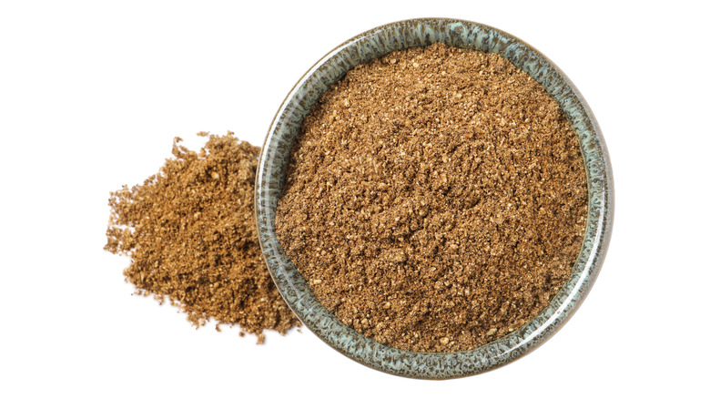 Cumin powder in blue bowl