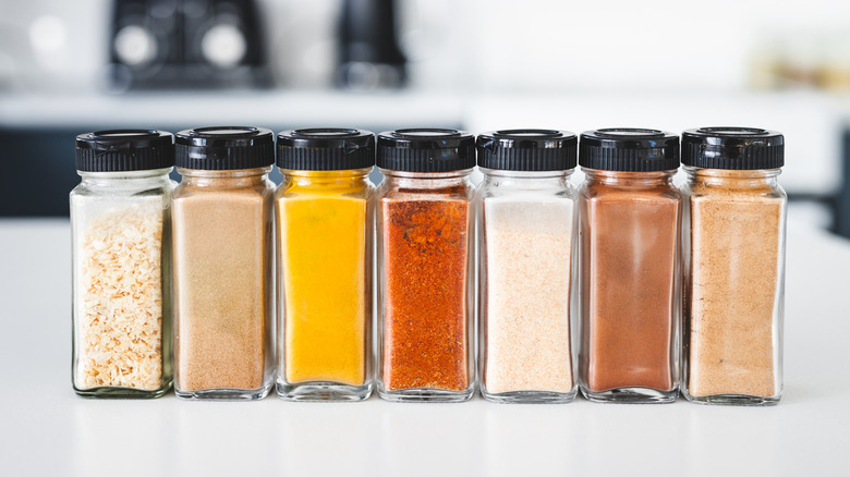 Spices arranged on white kitchen countertop