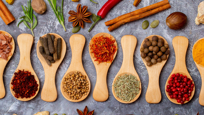 Various spices on wooden spoons