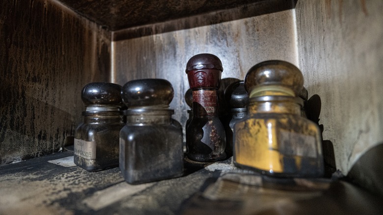 Spices and seasonings neglected in dusty cupboard