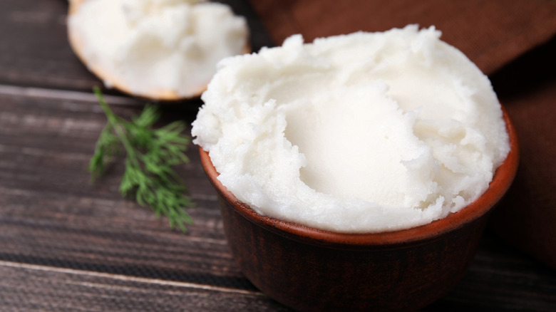 Pork lard in wooden bowl on table