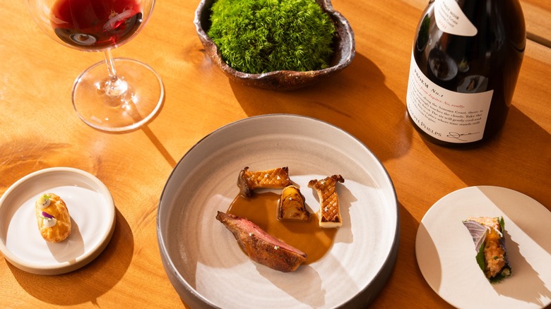 Roasted duck with mushrooms, canapes, and red wine.