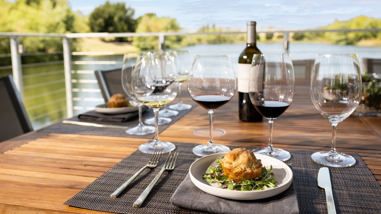 Wine glasses with wine bottle and plate of puff pastry