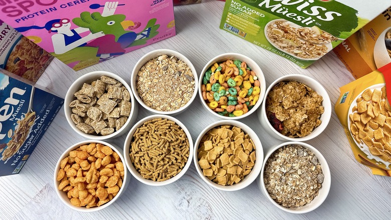 8 bowls of cereal and cereal boxes