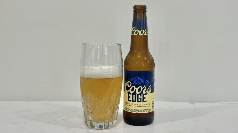 Coors Edge beer poured out into a glass.