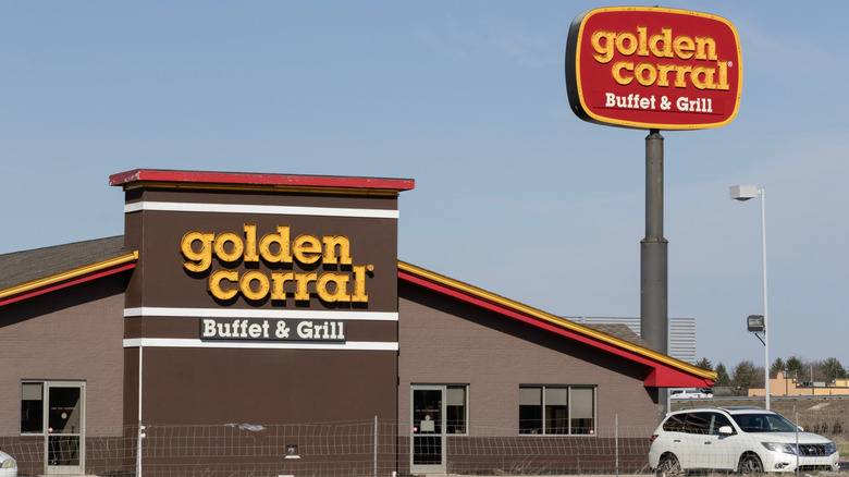 Exterior shot of Golden Corral and tall sign against blue sky