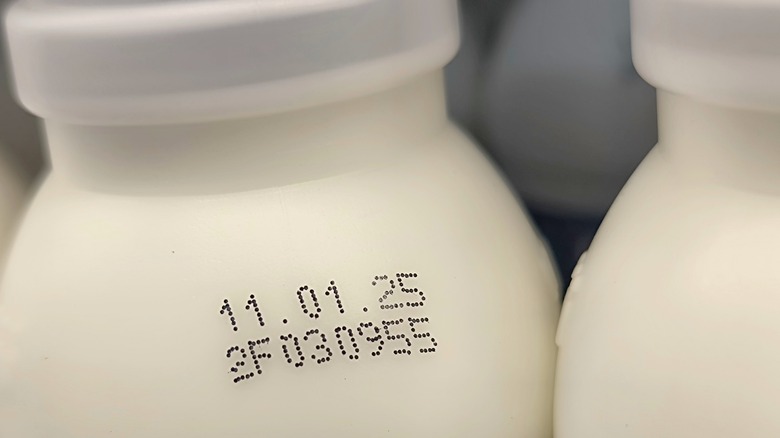 close up of white bottle with expiration date