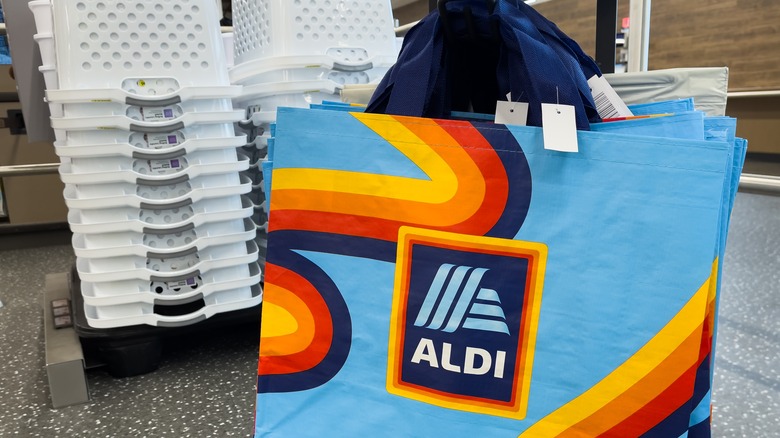 row of hanging blue reusable Aldi bags