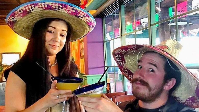 A man and woman wearing sombreros