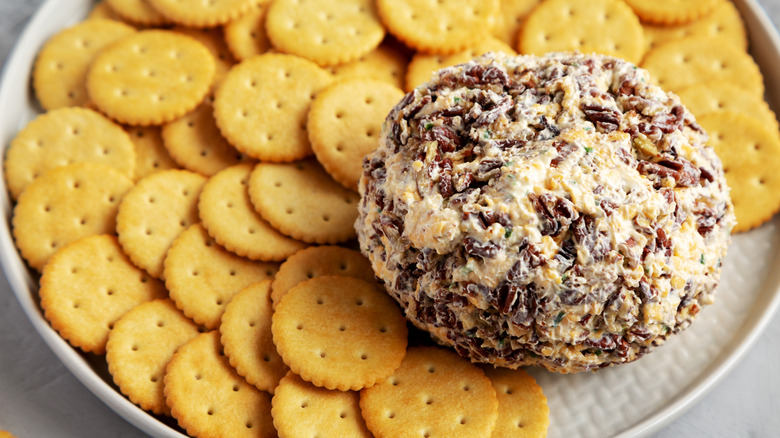 a nut-encrusted cheese ball with crackers