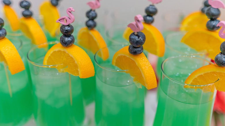 a green fruity punch served in glasses with garnishes