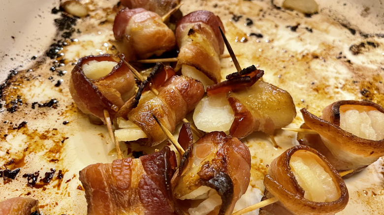 a plate with rumaki on toothpicks
