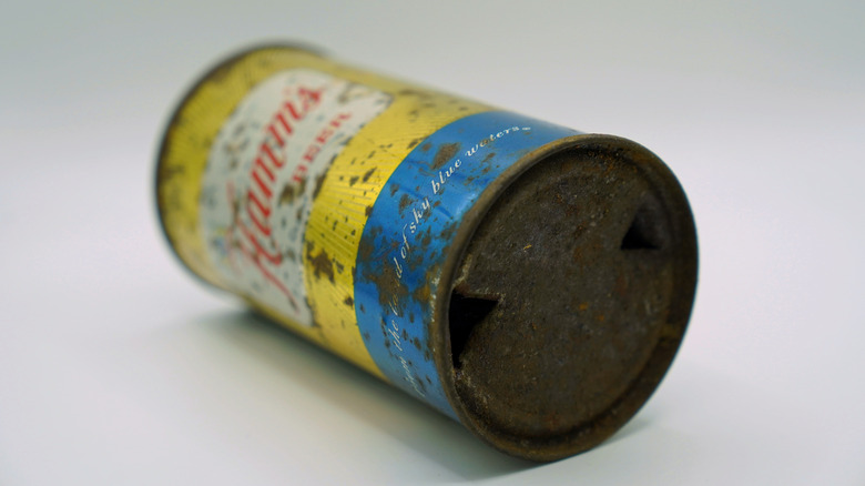 A vintage, flat top can of Hamm's beer, laying on its side and isolated on a white background.